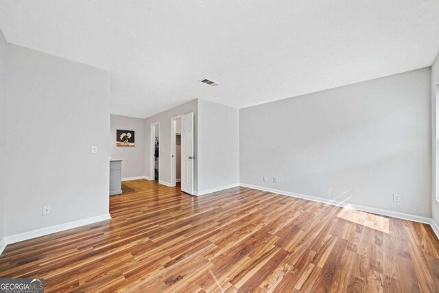 717 Beaufort Cir, Duluth, GA 30096 - unfurnished living room with wood finished floors and baseboards