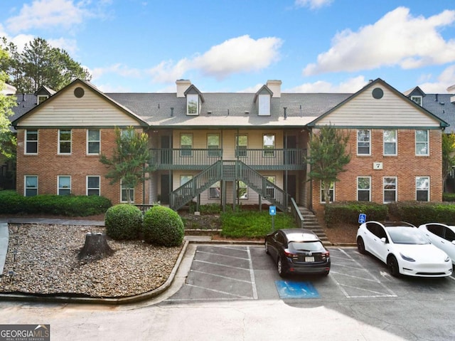 717 Beaufort Cir, Duluth, GA 30096 - view of building exterior with stairway and uncovered parking