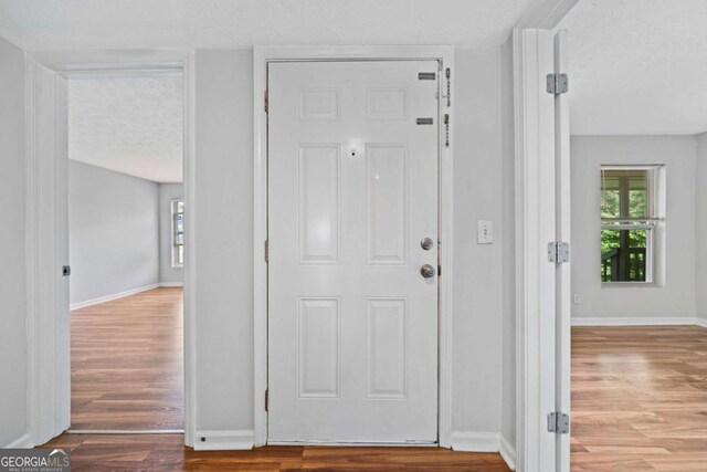 717 Beaufort Cir, Duluth, GA 30096 - entryway featuring wood finished floors, a textured ceiling, and baseboards