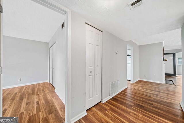 717 Beaufort Cir, Duluth, GA 30096 - hall with wood finished floors, baseboards, and a textured ceiling