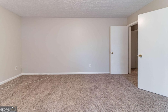 5614 Regency Forest Ct, Lithonia, GA 30038 - spare room featuring carpet flooring, a textured ceiling, and baseboards