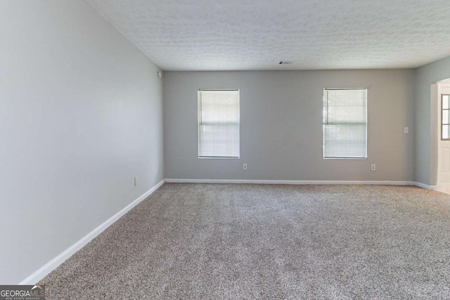 5614 Regency Forest Ct, Lithonia, GA 30038 - empty room with carpet and a textured ceiling