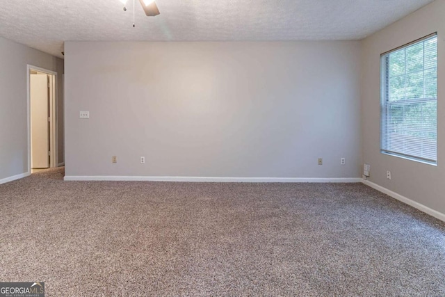5614 Regency Forest Ct, Lithonia, GA 30038 - carpeted empty room featuring a textured ceiling, baseboards, and a ceiling fan