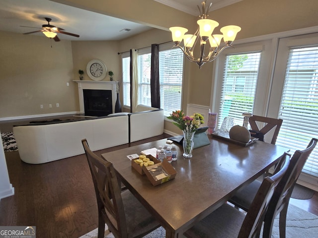 4860 Berkeley Glen Dr, Peachtree Corners, GA 30092 - dining space featuring wood finished floors, a chandelier, a fireplace, ceiling fan, and crown molding