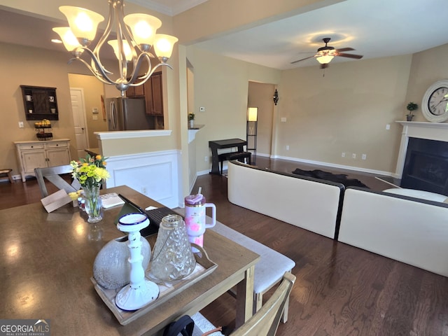 4860 Berkeley Glen Dr, Peachtree Corners, GA 30092 - dining room with dark wood-style floors, a fireplace with flush hearth, a chandelier, a ceiling fan, and ornamental molding
