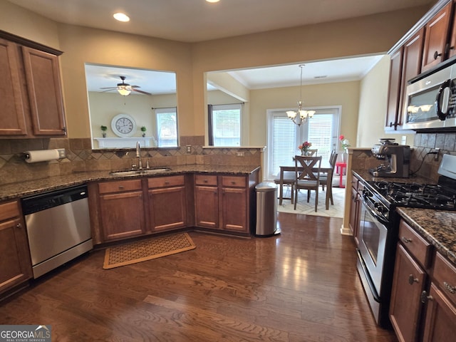4860 Berkeley Glen Dr, Peachtree Corners, GA 30092 - kitchen featuring appliances with stainless steel finishes, a sink, dark wood-type flooring, recessed lighting, and a chandelier