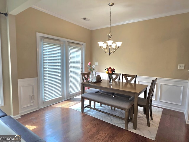 4860 Berkeley Glen Dr, Peachtree Corners, GA 30092 - dining area with wood finished floors, crown molding, a chandelier, wainscoting, and a decorative wall