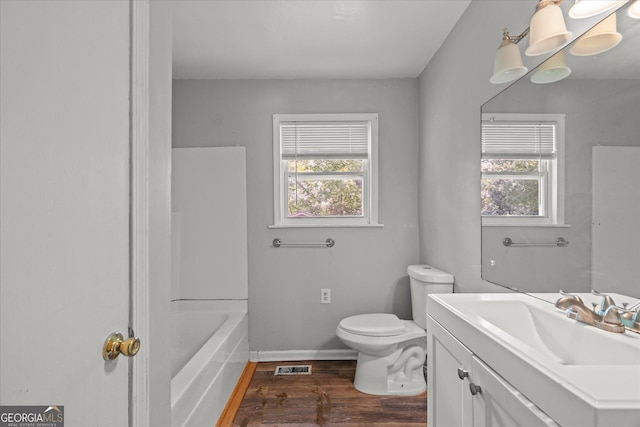 423 Clifton Ter, Carrollton, GA 30117 - bathroom featuring vanity, wood finished floors, toilet, and baseboards