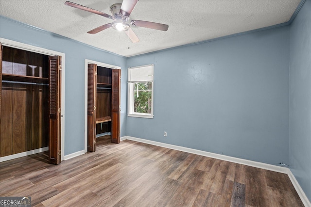 423 Clifton Ter, Carrollton, GA 30117 - unfurnished bedroom with wood finished floors, a textured ceiling, baseboards, and ceiling fan