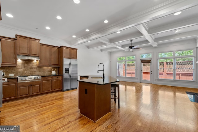661 Lockton Pl # 9, Sandy Springs, GA 30342 - kitchen featuring stainless steel fridge with ice dispenser, a sink, a ceiling fan, dark countertops, and light wood finished floors