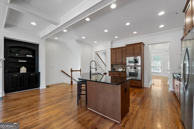 661 Lockton Pl # 9, Sandy Springs, GA 30342 - kitchen featuring appliances with stainless steel finishes, dark countertops, crown molding, a breakfast bar, and recessed lighting