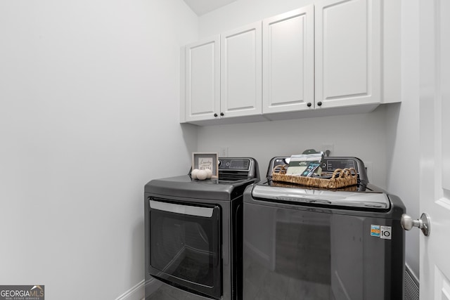 661 Lockton Pl # 9, Sandy Springs, GA 30342 - washroom featuring cabinet space, washer and clothes dryer, and baseboards