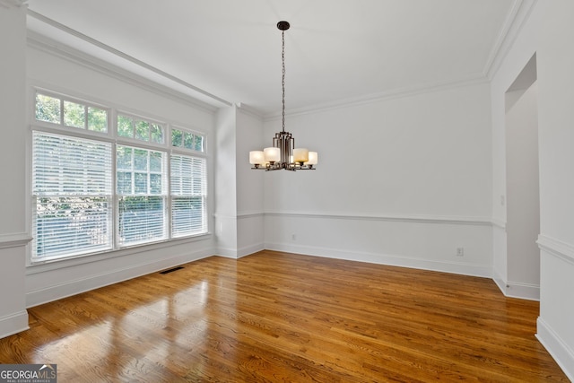 661 Lockton Pl # 9, Sandy Springs, GA 30342 - empty room with a chandelier, wood finished floors, ornamental molding, and baseboards