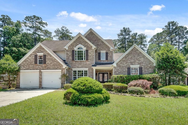 543 Serene Waters Trl, Jonesboro, GA 30236 - traditional-style home featuring concrete driveway, a front lawn, brick siding, and french doors