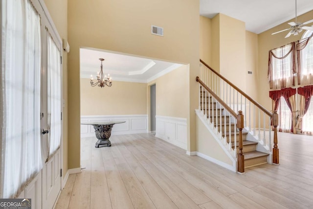 543 Serene Waters Trl, Jonesboro, GA 30236 - entryway with a chandelier, wood finished floors, stairs, wainscoting, and ornamental molding
