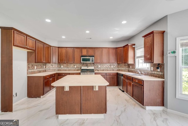 543 Serene Waters Trl, Jonesboro, GA 30236 - kitchen featuring stainless steel appliances, a center island, tasteful backsplash, healthy amount of natural light, and recessed lighting