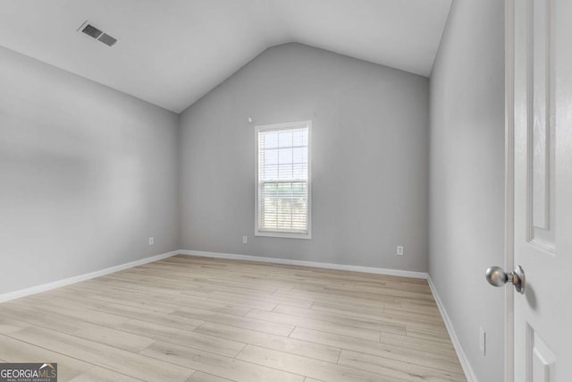 543 Serene Waters Trl, Jonesboro, GA 30236 - spare room featuring light wood-style flooring, vaulted ceiling, and baseboards