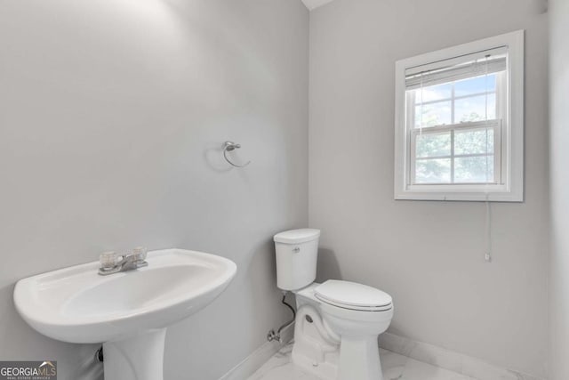 543 Serene Waters Trl, Jonesboro, GA 30236 - bathroom with baseboards, toilet, marble look tiles, and a sink