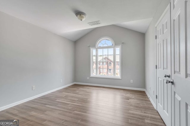 543 Serene Waters Trl, Jonesboro, GA 30236 - unfurnished bedroom with lofted ceiling and wood finished floors