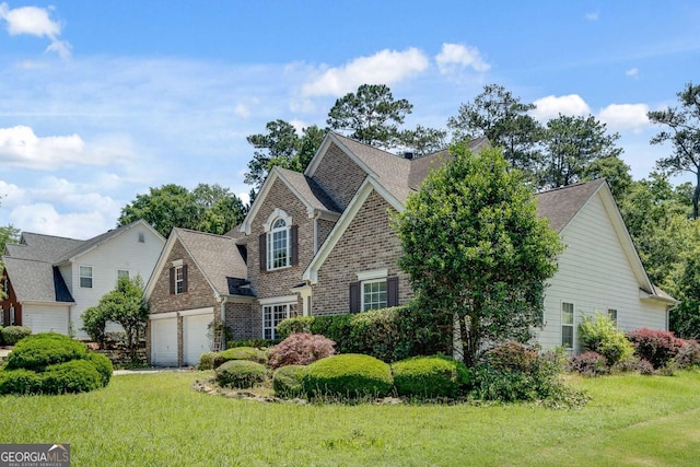 543 Serene Waters Trl, Jonesboro, GA 30236 - view of front facade featuring a front lawn, a shingled roof, and brick siding