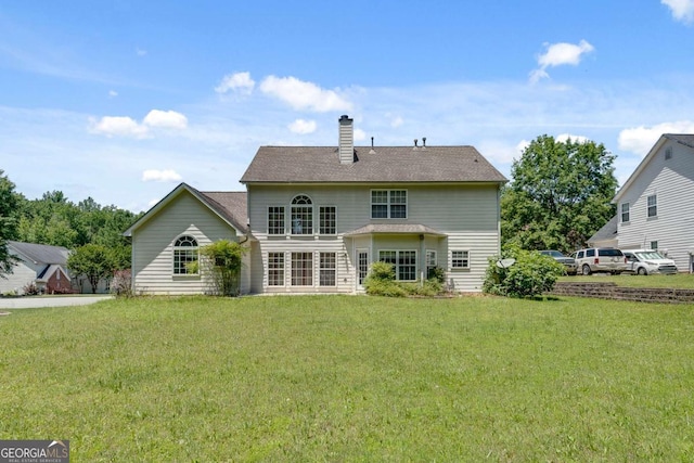 543 Serene Waters Trl, Jonesboro, GA 30236 - rear view of property featuring a chimney and a lawn