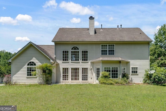 543 Serene Waters Trl, Jonesboro, GA 30236 - back of house with a yard and a chimney