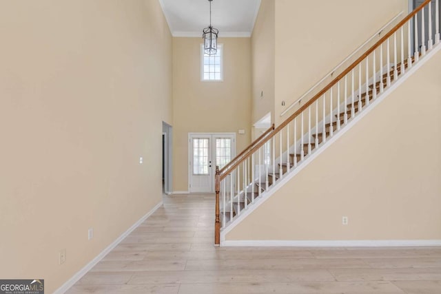 543 Serene Waters Trl, Jonesboro, GA 30236 - entryway featuring stairs, wood finished floors, baseboards, ornamental molding, and a high ceiling