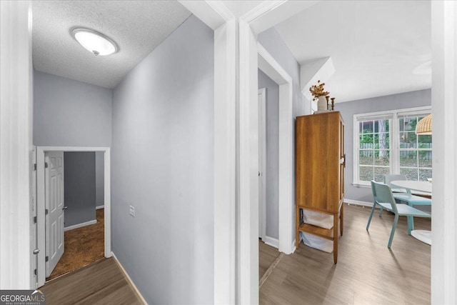 1359 Chatley Way, Woodstock, GA 30188 - corridor featuring wood finished floors, baseboards, and a textured ceiling