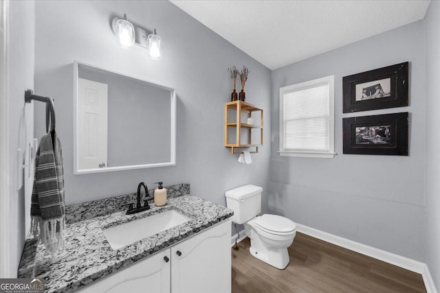 1359 Chatley Way, Woodstock, GA 30188 - bathroom featuring toilet, wood finished floors, vanity, lofted ceiling, and baseboards