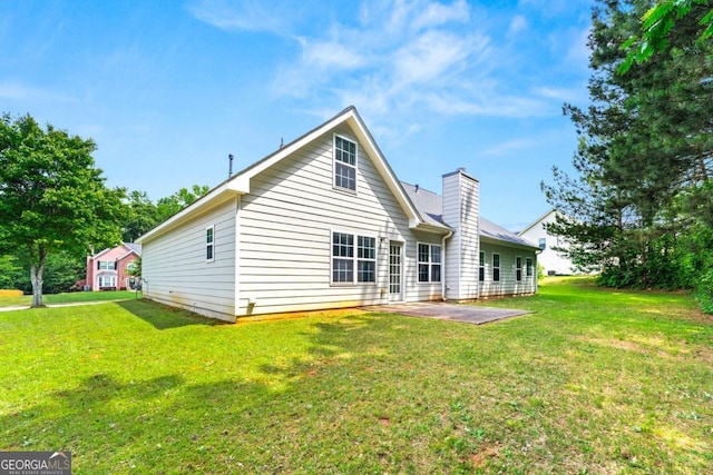 85 Old Gettysburg Way, Dallas, GA 30157 - rear view of house featuring a patio area, a lawn, and a chimney