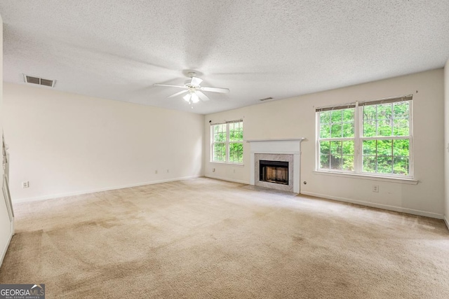 85 Old Gettysburg Way, Dallas, GA 30157 - unfurnished living room featuring ceiling fan, a premium fireplace, carpet, baseboards, and a textured ceiling