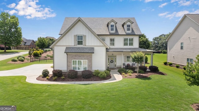 485 Delaperriere Loop, Jefferson, GA 30549 - view of front of home featuring board and batten siding, brick siding, a front lawn, a shingled roof, and covered porch