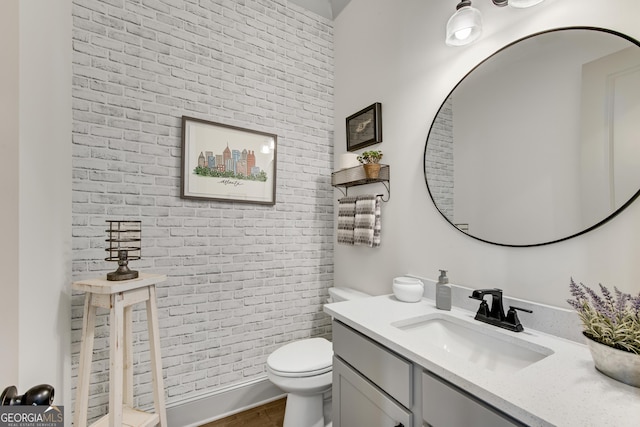 485 Delaperriere Loop, Jefferson, GA 30549 - bathroom with vanity, brick wall, and wood finished floors