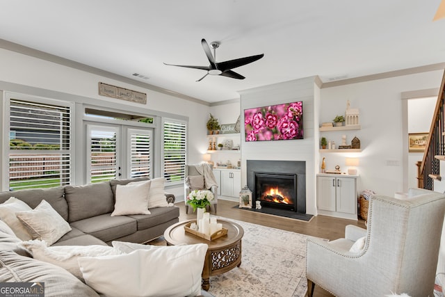485 Delaperriere Loop, Jefferson, GA 30549 - living area with ceiling fan, light wood-style flooring, a glass covered fireplace, and crown molding