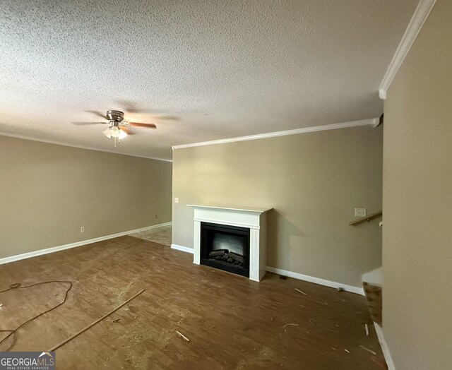 261 Sally Duke Dr, Whitesburg, GA 30185 - unfurnished living room featuring crown molding, ceiling fan, a fireplace, a textured ceiling, and baseboards