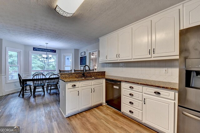 1882 Flowering Dr, Grayson, GA 30017 - kitchen featuring stainless steel fridge with ice dispenser, black dishwasher, a sink, light wood-type flooring, and a peninsula