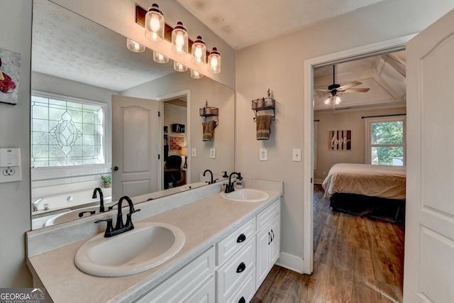 1882 Flowering Dr, Grayson, GA 30017 - ensuite bathroom featuring double vanity, ceiling fan, wood finished floors, and baseboards
