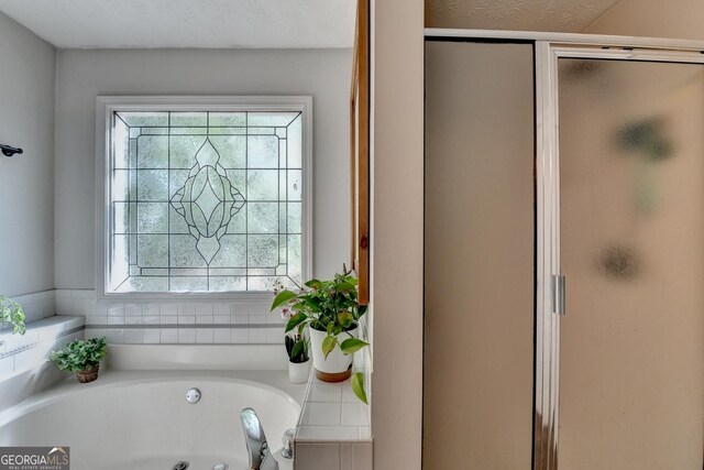 1882 Flowering Dr, Grayson, GA 30017 - bathroom featuring a shower stall and a tub with jets