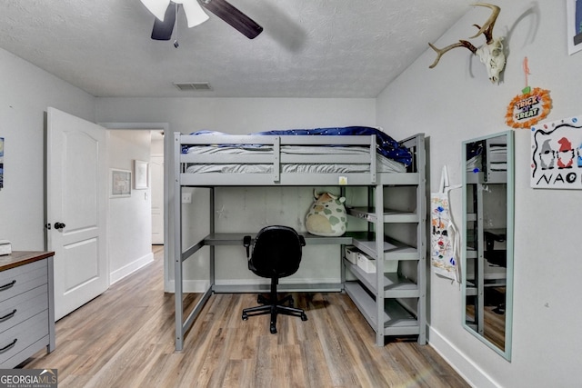 1882 Flowering Dr, Grayson, GA 30017 - bedroom featuring light wood-style floors, a desk, baseboards, and a textured ceiling