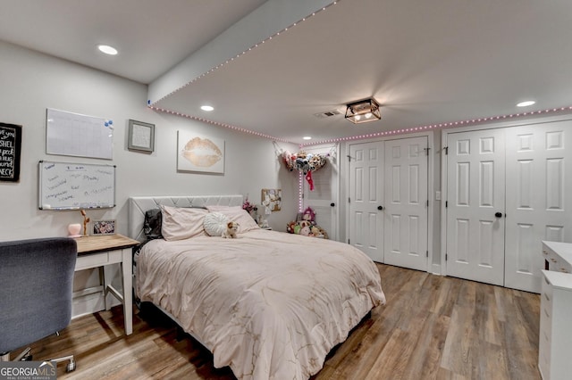 1882 Flowering Dr, Grayson, GA 30017 - bedroom featuring multiple closets, wood finished floors, and recessed lighting