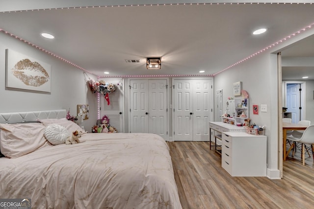 1882 Flowering Dr, Grayson, GA 30017 - bedroom with multiple closets, wood finished floors, and recessed lighting