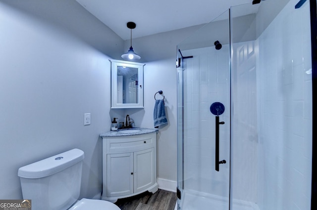 1882 Flowering Dr, Grayson, GA 30017 - bathroom with a stall shower, vanity, toilet, and wood finished floors
