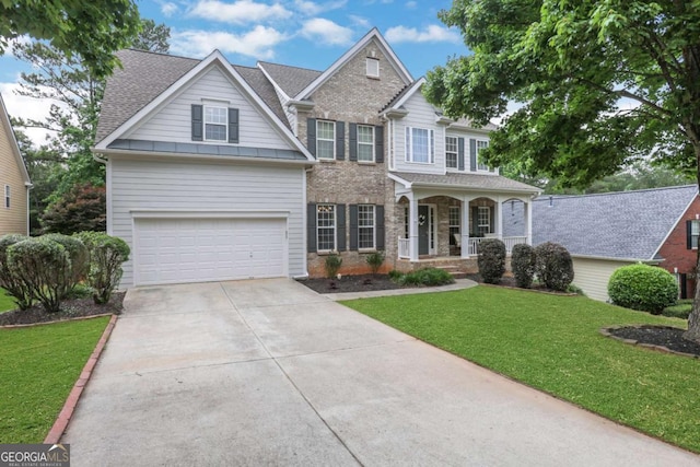 3980 Suwanee Place Dr, Suwanee, GA 30024 - traditional home featuring concrete driveway, covered porch, a front yard, a garage, and brick siding