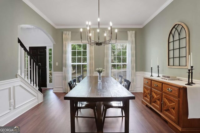 3980 Suwanee Place Dr, Suwanee, GA 30024 - dining room with a chandelier, dark wood-style flooring, crown molding, wainscoting, and a decorative wall