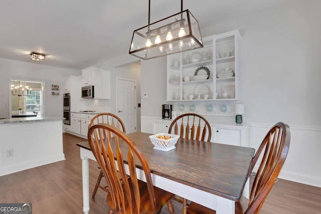3980 Suwanee Place Dr, Suwanee, GA 30024 - dining room with a chandelier and dark wood-type flooring