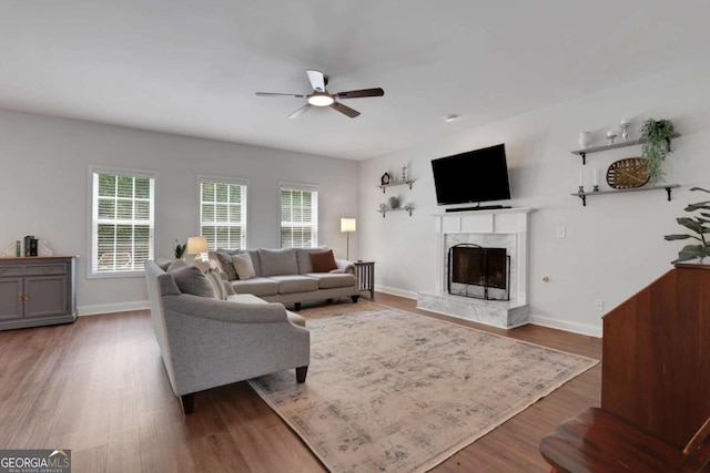 3980 Suwanee Place Dr, Suwanee, GA 30024 - living room featuring ceiling fan, a high end fireplace, baseboards, and wood finished floors