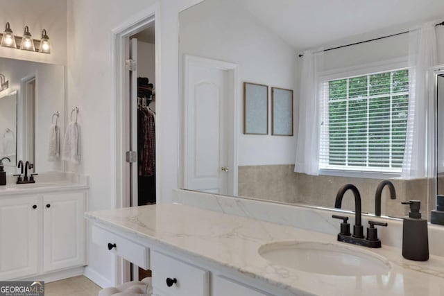 3980 Suwanee Place Dr, Suwanee, GA 30024 - bathroom featuring two vanities and a spacious closet