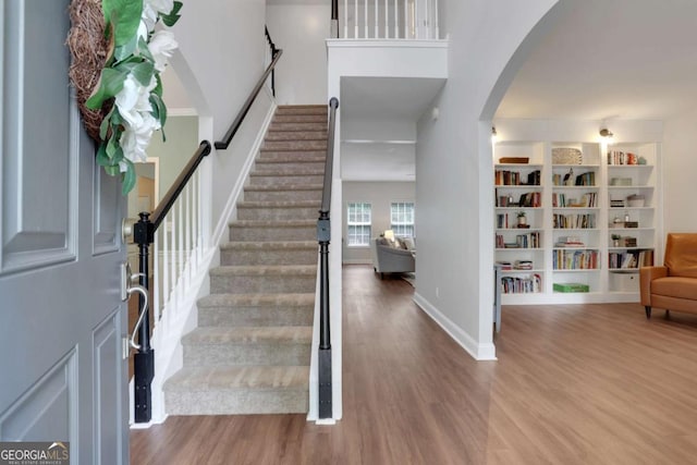 3980 Suwanee Place Dr, Suwanee, GA 30024 - foyer entrance featuring wood finished floors, arched walkways, baseboards, and stairs