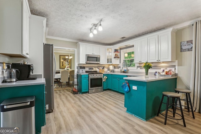 135 Clubhouse Dr NW, Kennesaw, GA 30144 - kitchen with stainless steel appliances, light wood-style flooring, white cabinets, crown molding, and a textured ceiling