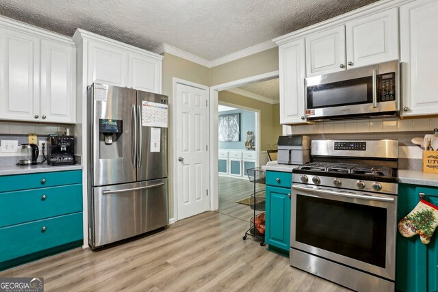 135 Clubhouse Dr NW, Kennesaw, GA 30144 - kitchen with stainless steel appliances, white cabinetry, decorative backsplash, ornamental molding, and a textured ceiling